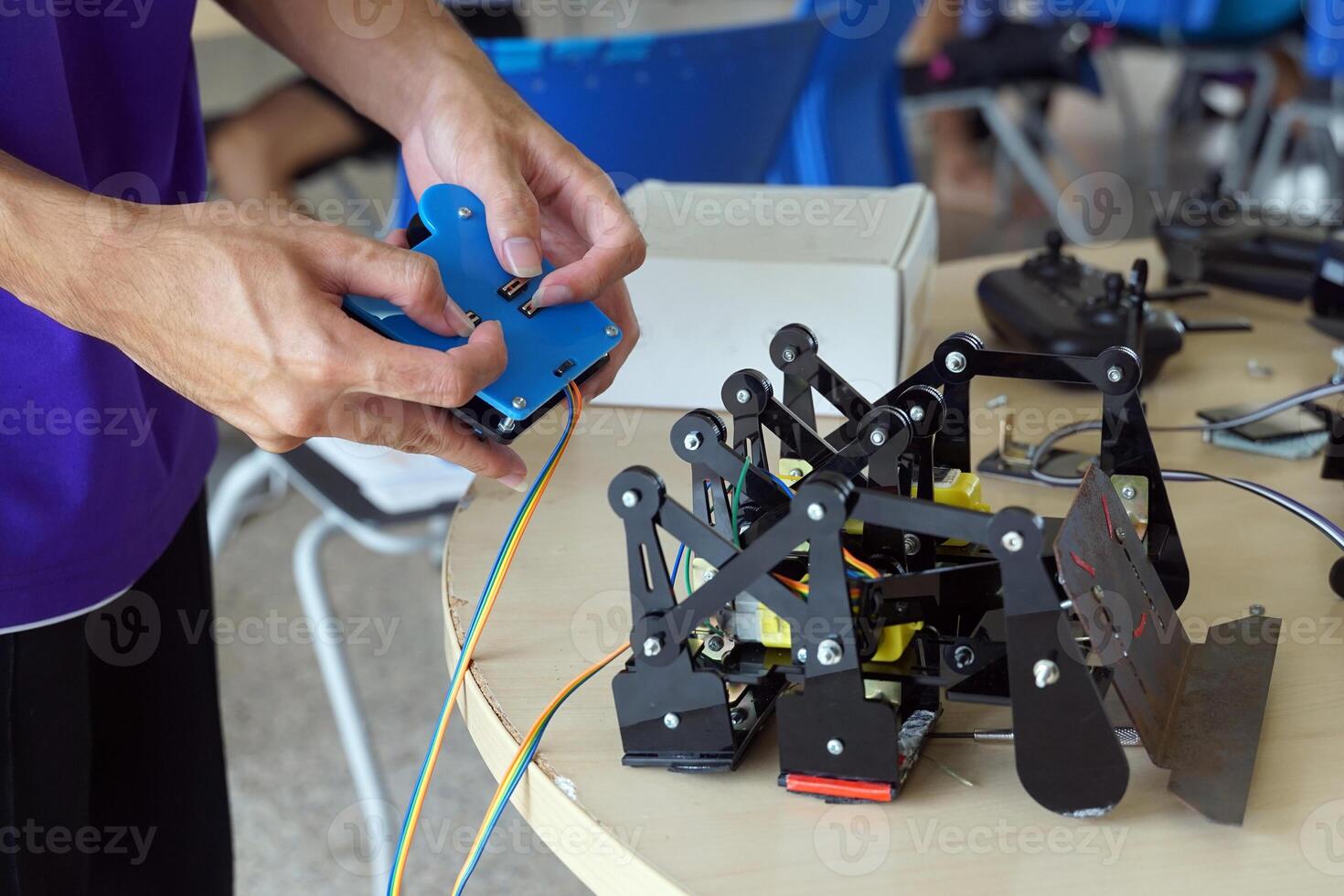 Asian high school students practice moving robots on the playing field To perform missions according to the rules of the robot competition. Soft and selective focus. photo