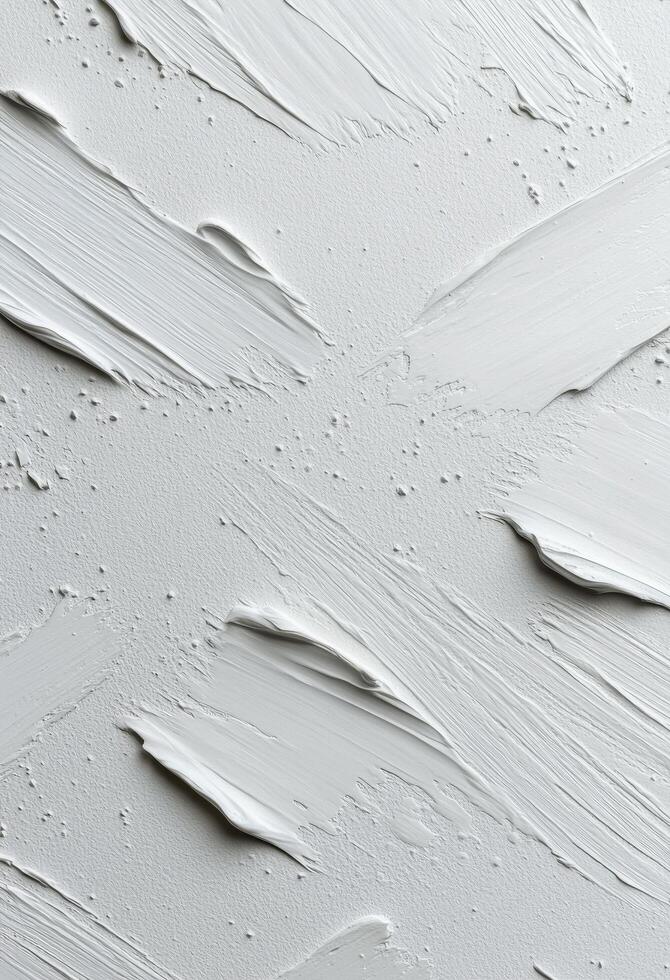 Textured white surface with paint strokes and uneven spots in natural light photo