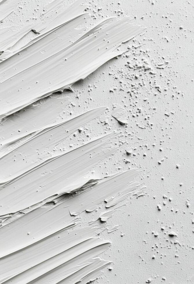 Textured white surface with paint strokes and uneven spots in natural light photo