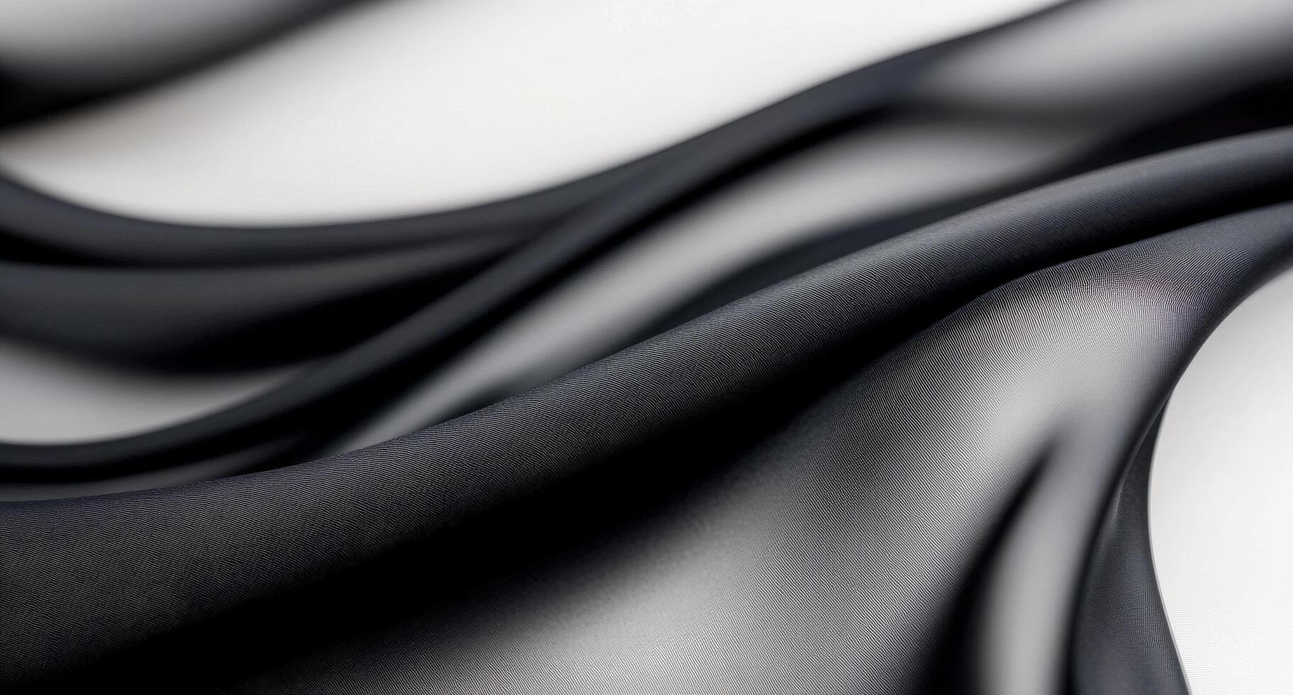 Smooth black fabric draping elegantly on a white surface photo