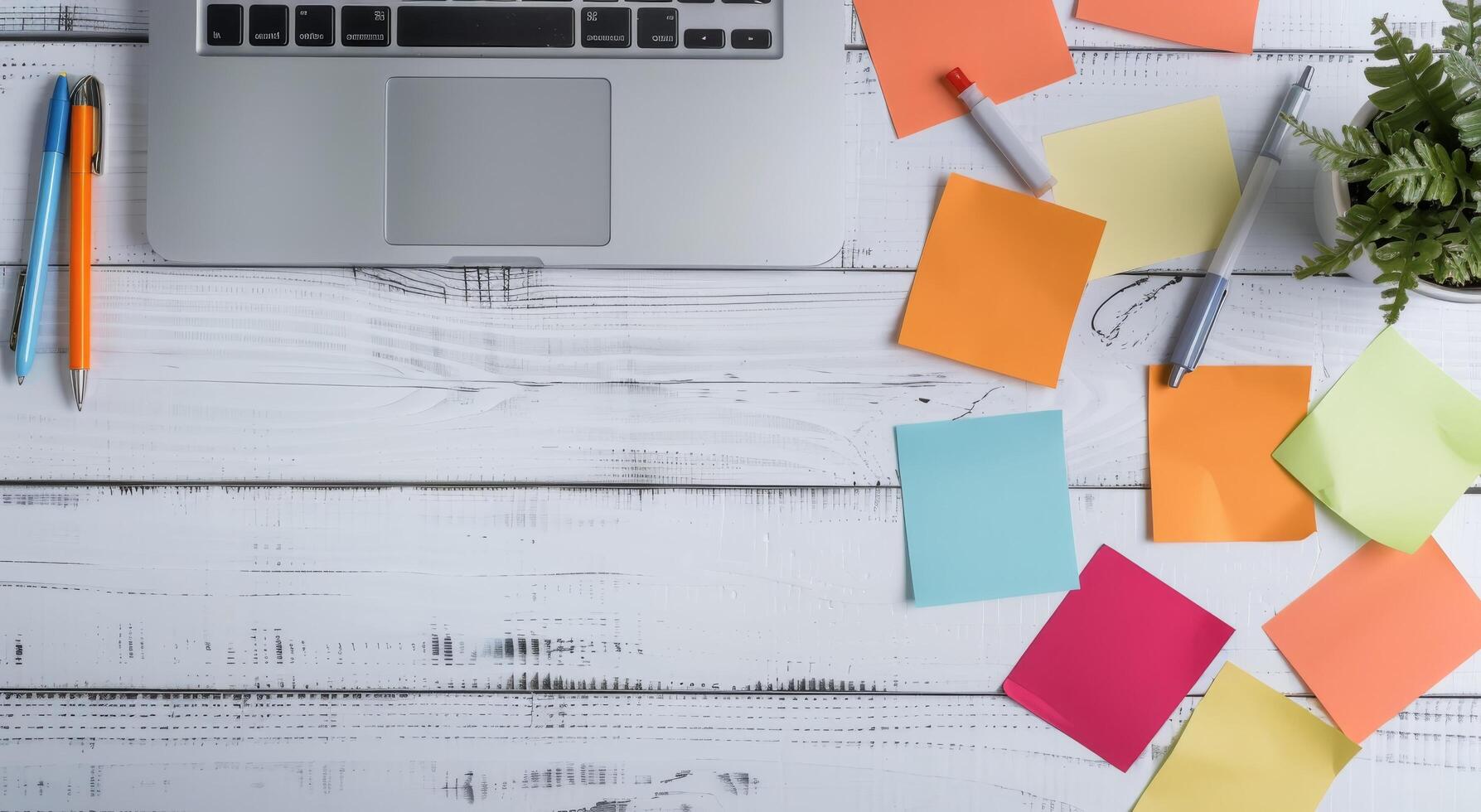 Laptop Surrounded by Colorful Sticky Notes on Wooden Desk photo