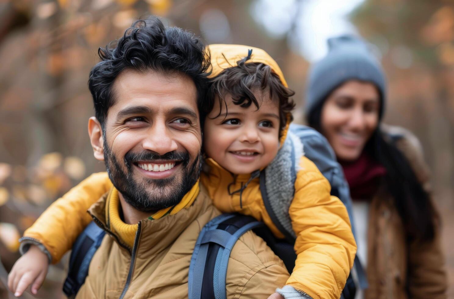 Family Enjoying Autumn Hike in Forest With Child on Father's Back photo