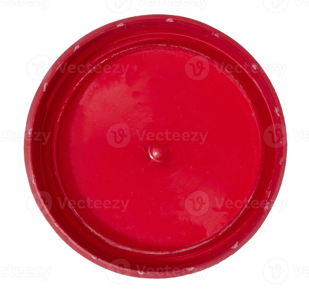 Red plastic bottle cap on isolated background, top view photo