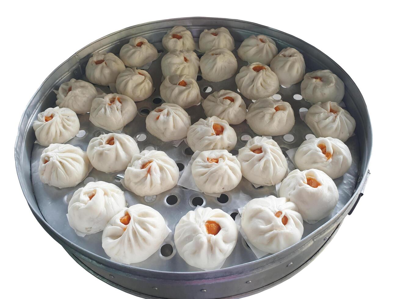 Clean white dough buns filled with pork and red salted eggs on top in an aluminum steamer on a white background. photo