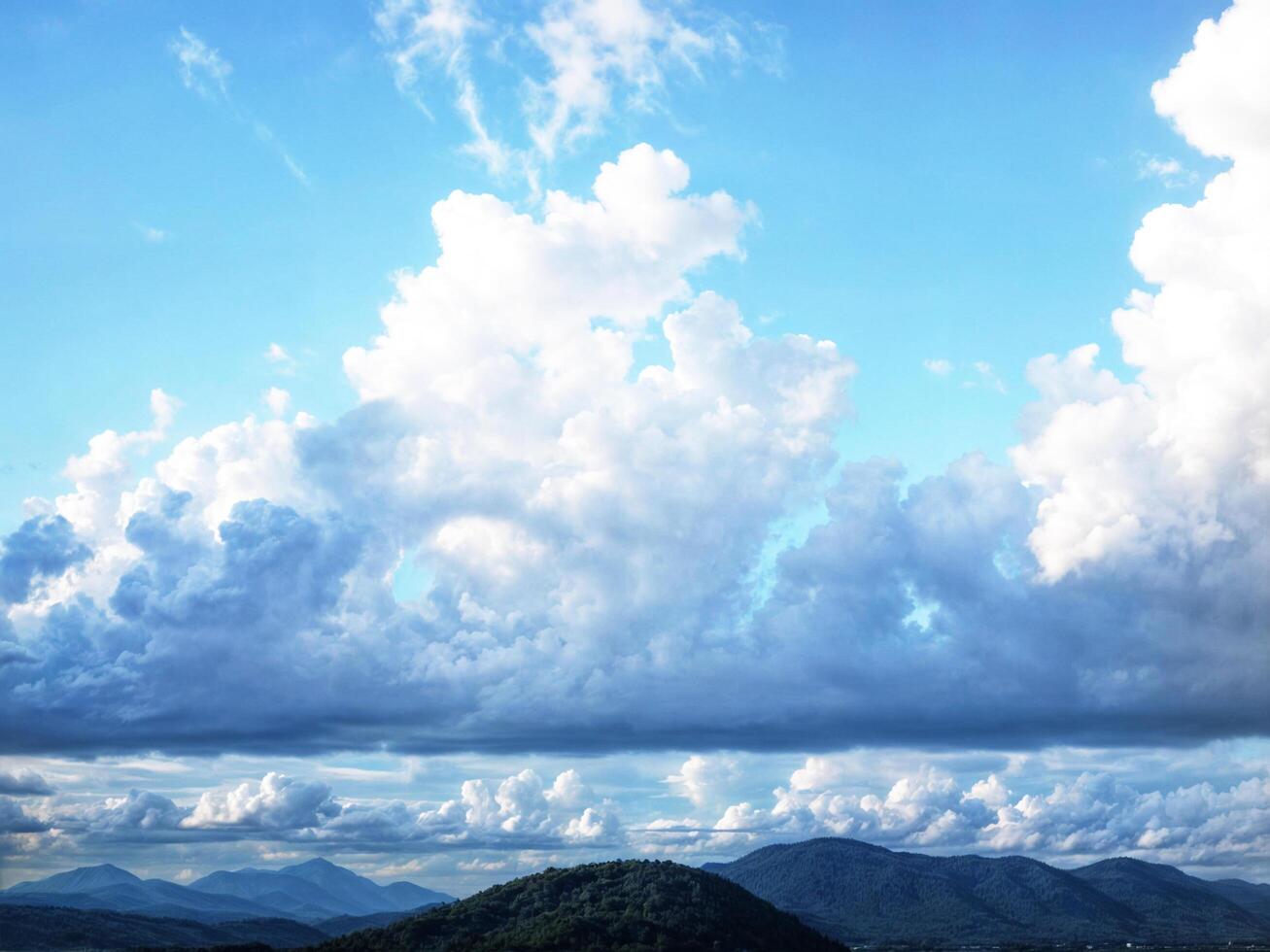 2 layer cloudy big and small and mountain photo