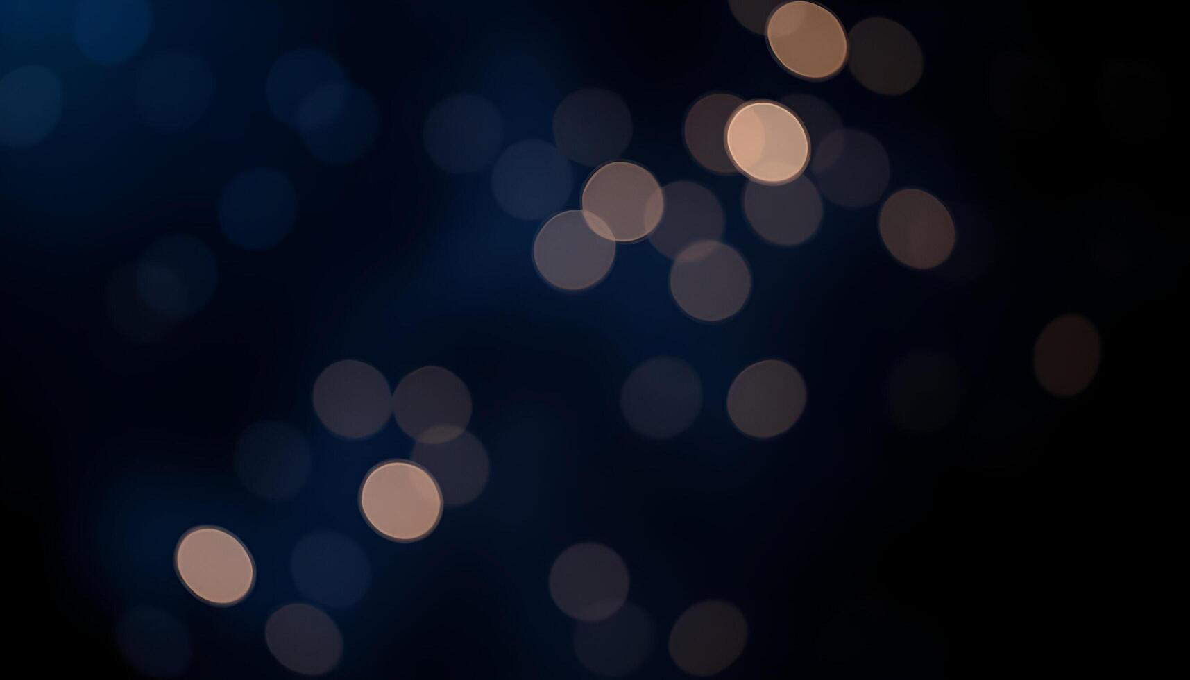 a blurry image of a dark background with lights photo