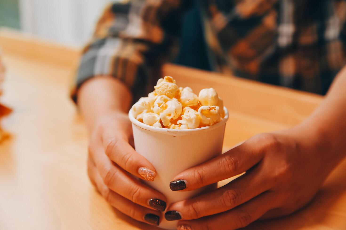 A woman holding a bowl of popcorn photo
