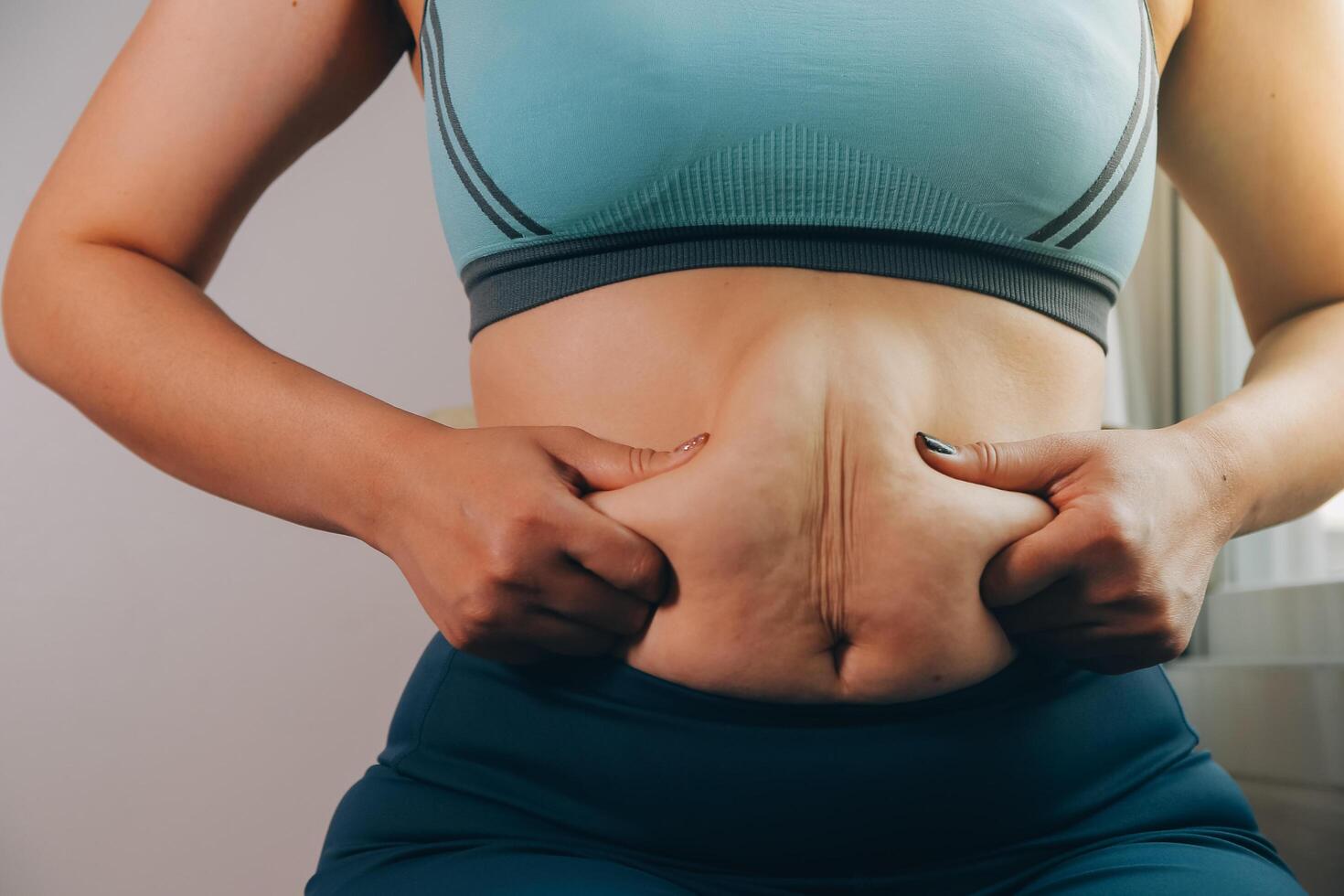 fat woman, fat belly, chubby, obese woman hand holding excessive belly fat with measure tape, woman diet lifestyle concept photo