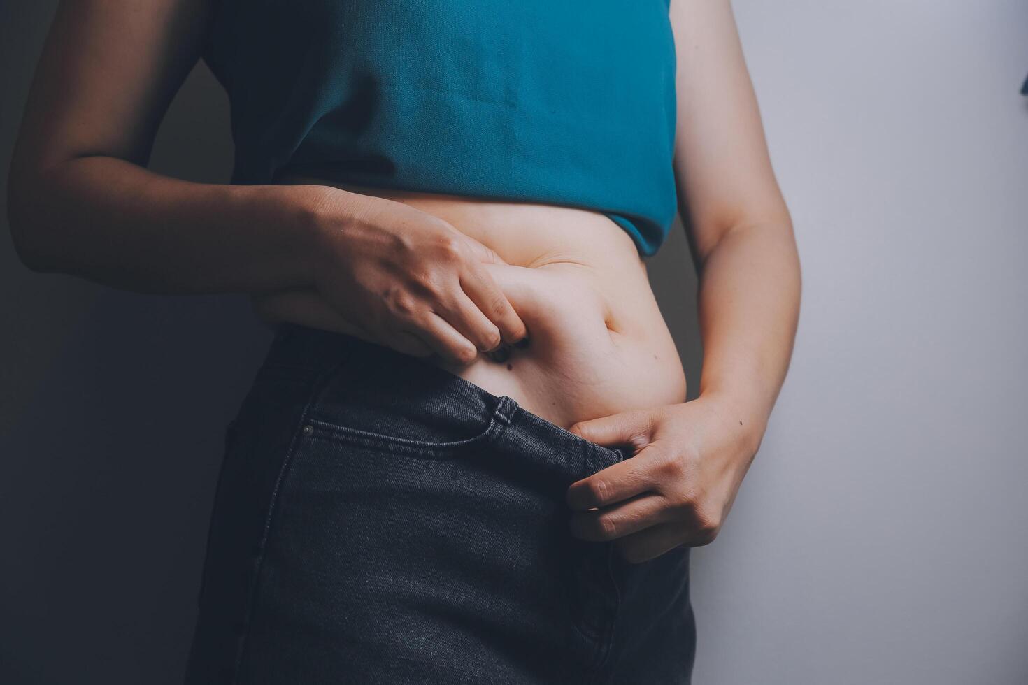 fat woman, fat belly, chubby, obese woman hand holding excessive belly fat with measure tape, woman diet lifestyle concept photo