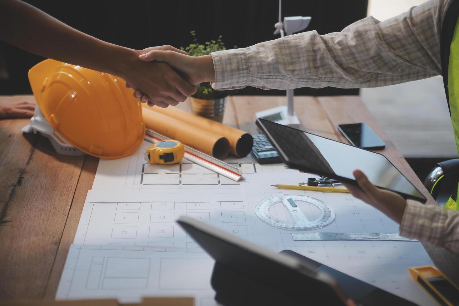 Architect men making handshake in construction site. Employee or worker shake hands to employer man for greeting, dealing, teamwork, collaboration some project or business. They are good team photo