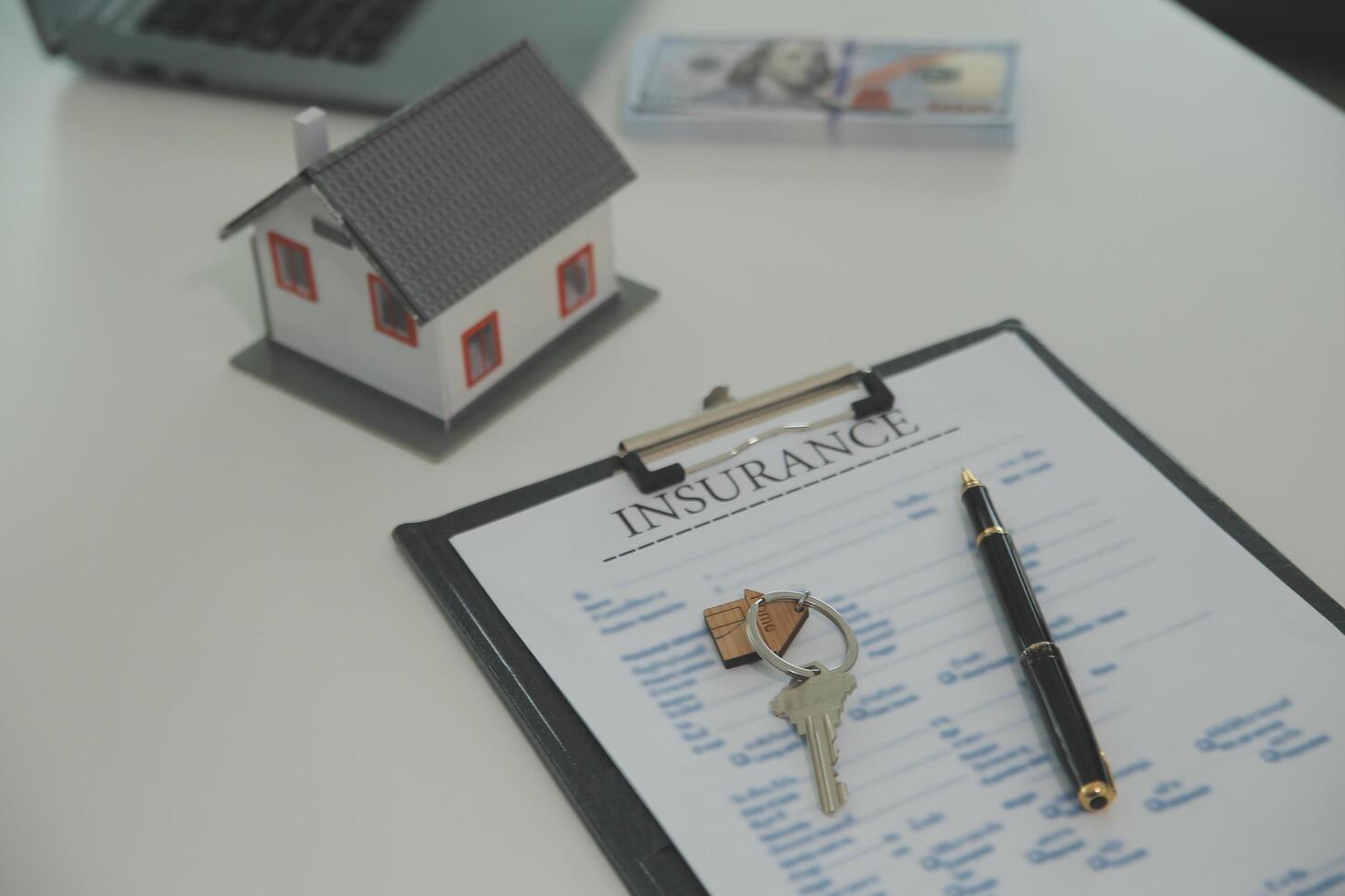 Real estate agent home sales broker is using a pen pointing to the house model and explains the business contract, rent, buy, mortgage, loan, or home insurance photo