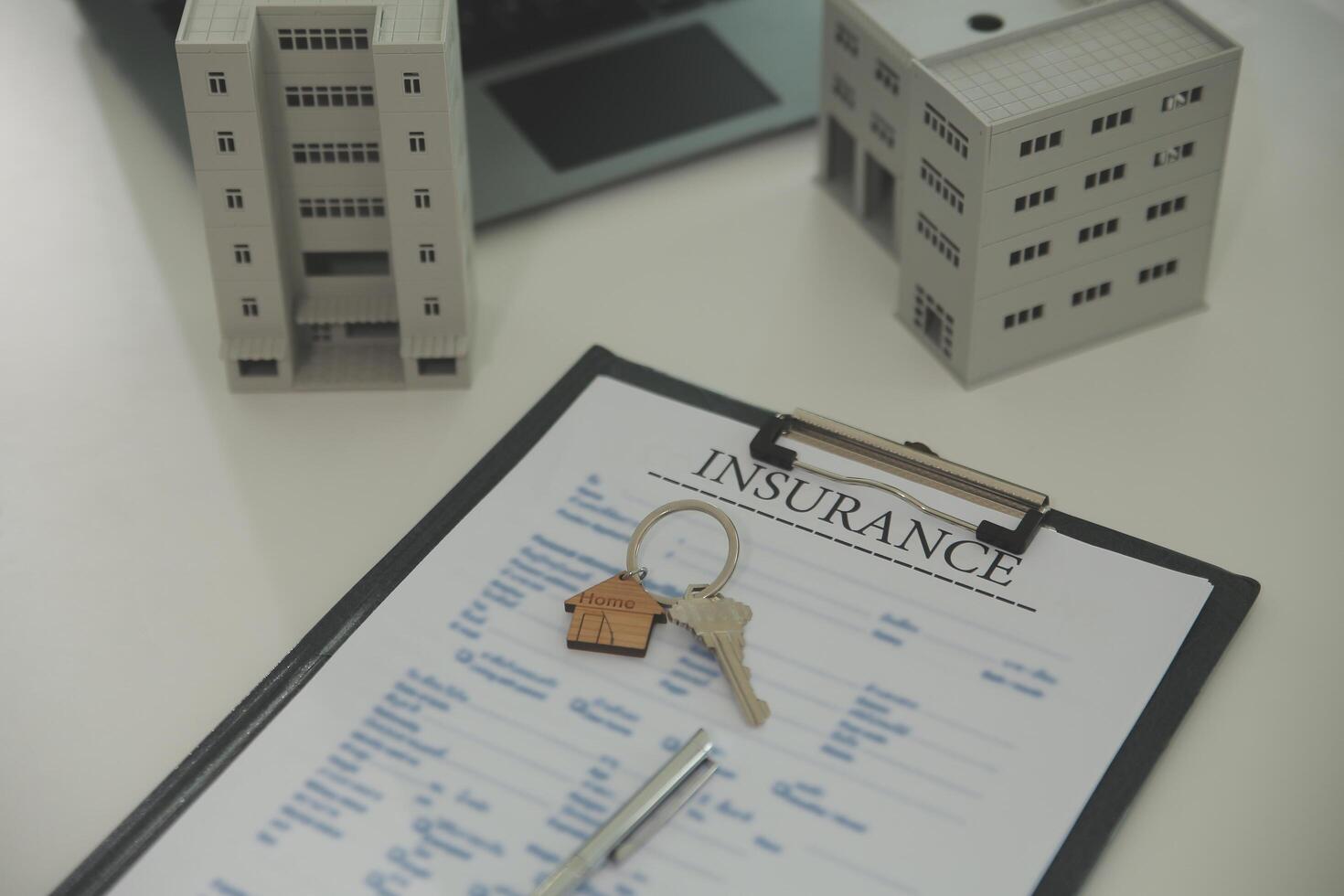 Real estate agent home sales broker is using a pen pointing to the house model and explains the business contract, rent, buy, mortgage, loan, or home insurance photo