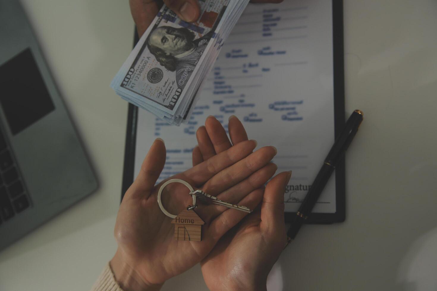 Real estate agent home sales broker is using a pen pointing to the house model and explains the business contract, rent, buy, mortgage, loan, or home insurance photo