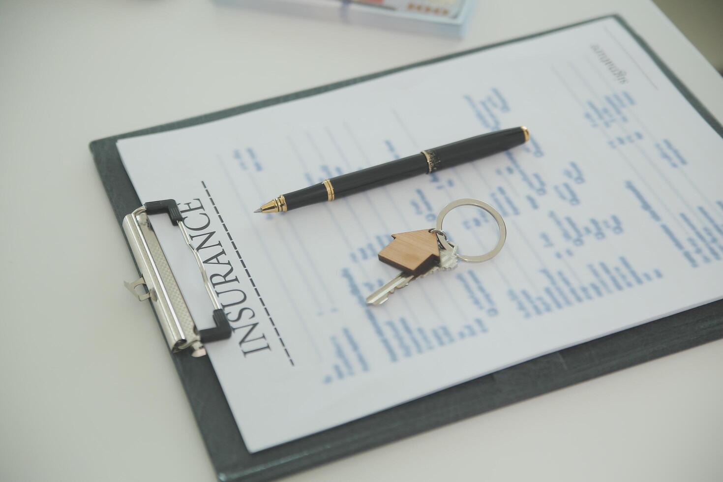 Real estate agent home sales broker is using a pen pointing to the house model and explains the business contract, rent, buy, mortgage, loan, or home insurance photo