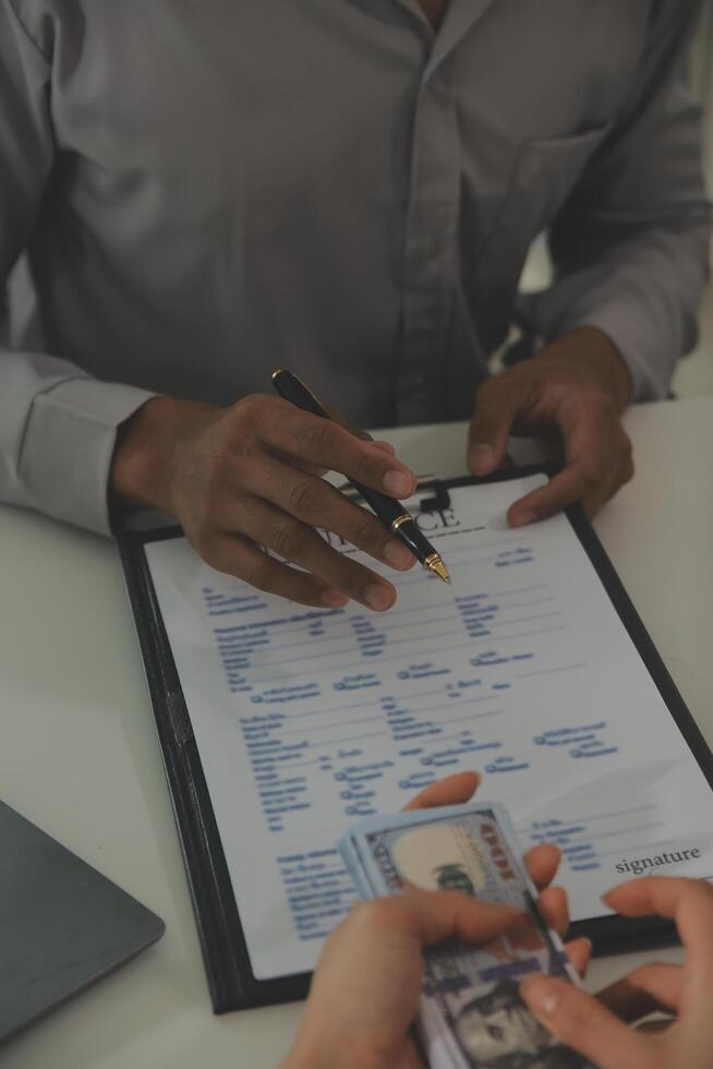 Real estate agent home sales broker is using a pen pointing to the house model and explains the business contract, rent, buy, mortgage, loan, or home insurance photo