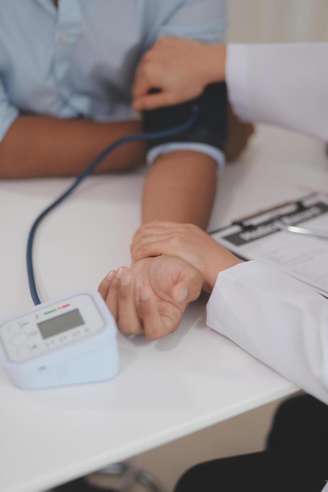 The doctor woman hand use the pulse meter to measure the pressure of the patient, medical checkup concept. photo