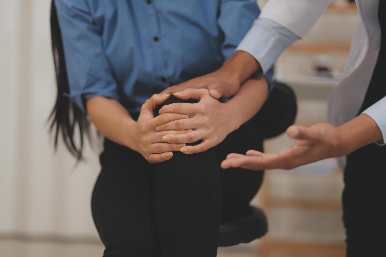 Professional orthopedist examining the little patient's leg in the clinic. Patient at the physiotherapy doing physical exercises with his therapist photo