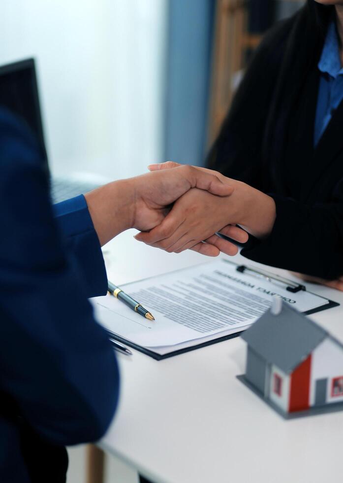 Sale representative offer house purchase contract to buy a house or apartment or discussing about loans and interest rates photo