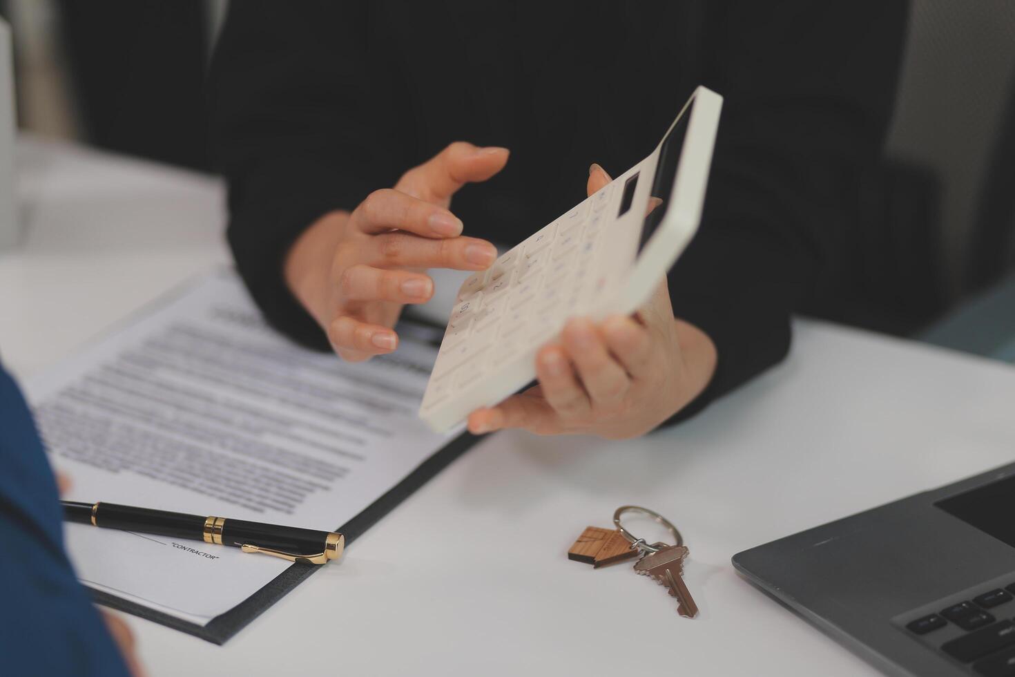 Sale representative offer house purchase contract to buy a house or apartment or discussing about loans and interest rates photo