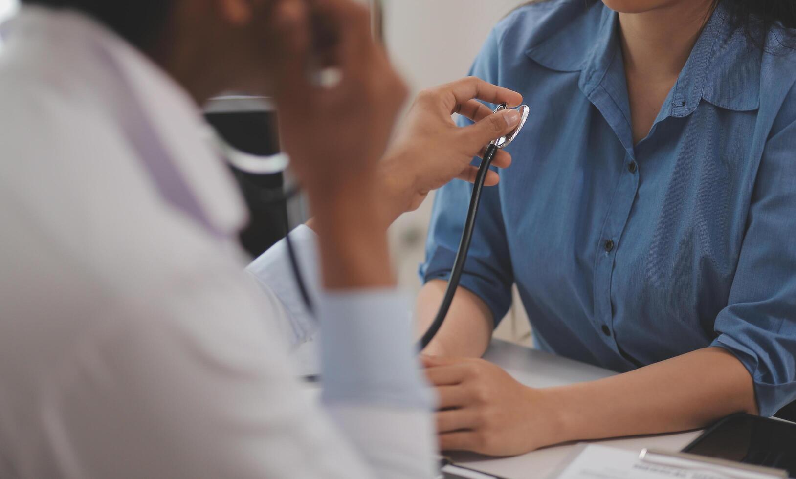 Doctor using a stethoscope checking patient with examining, presenting results symptom and recommend treatment method, Healthcare and medical concept. photo