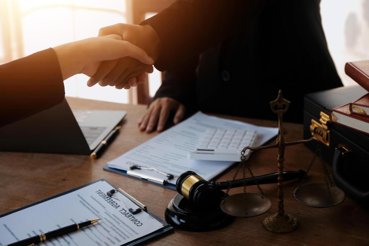concept of justice and law A male judge in the courtroom on a wooden table and a male counselor or lawyer working in the office. Law, advice and justice concepts. photo