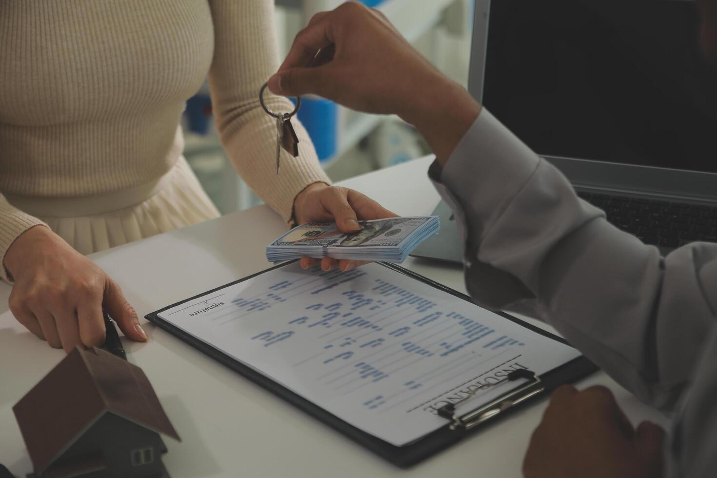 Real estate agent home sales broker is using a pen pointing to the house model and explains the business contract, rent, buy, mortgage, loan, or home insurance photo