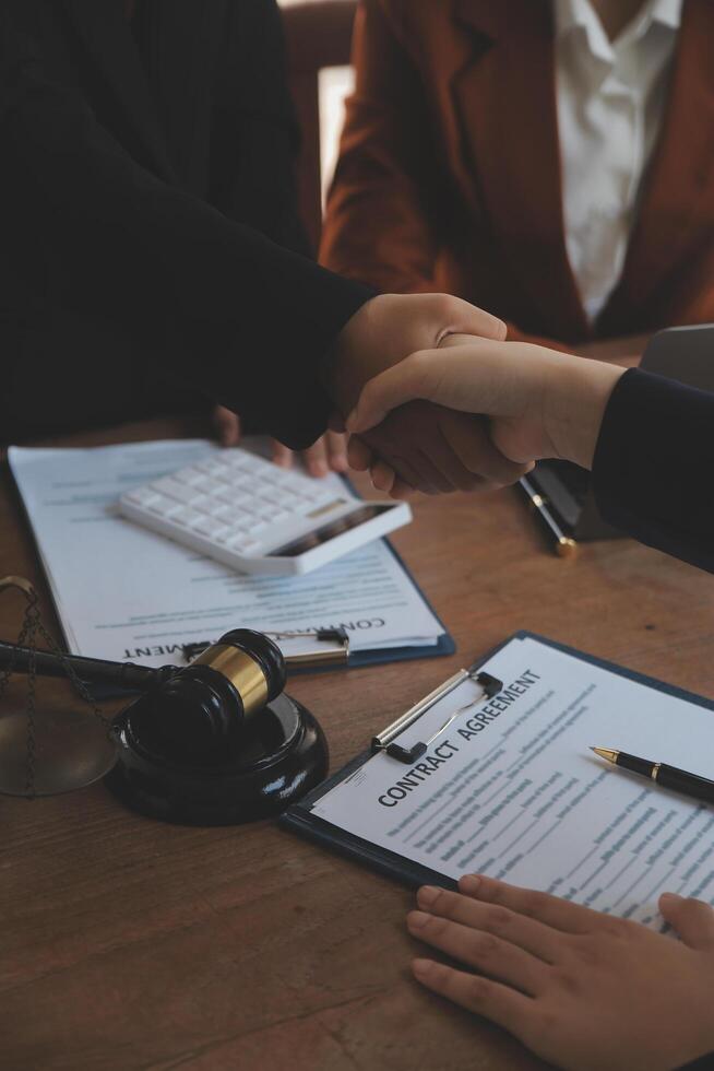 concept of justice and law A male judge in the courtroom on a wooden table and a male counselor or lawyer working in the office. Law, advice and justice concepts. photo