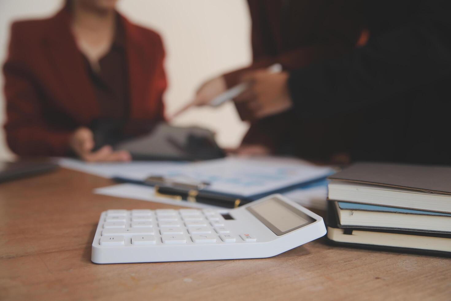 Group of confident business people point to graphs and charts to analyze market data, balance sheet, account, net profit to plan new sales strategies to increase production capacity. photo