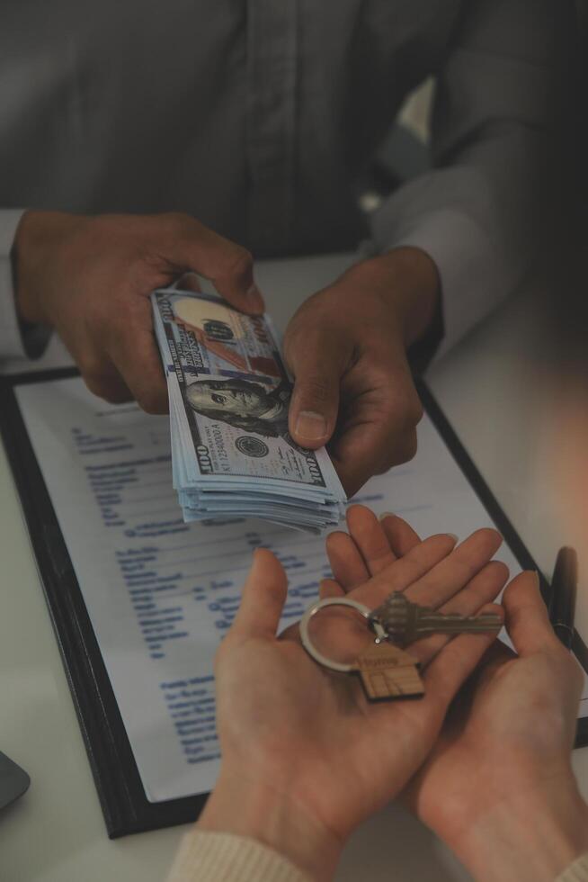 Real estate agent home sales broker is using a pen pointing to the house model and explains the business contract, rent, buy, mortgage, loan, or home insurance photo