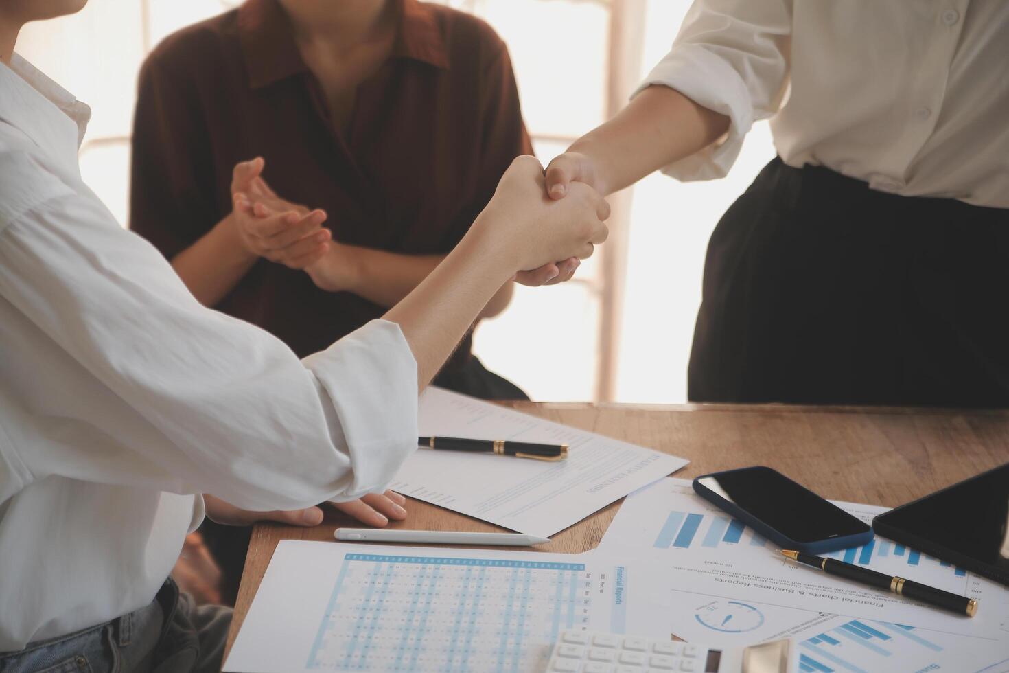 Leaders of business organizations join hands after the meeting is complete. Business partner meeting ideas. photo