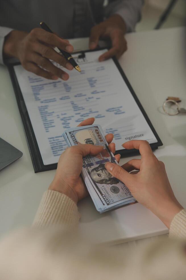 Real estate agent home sales broker is using a pen pointing to the house model and explains the business contract, rent, buy, mortgage, loan, or home insurance photo