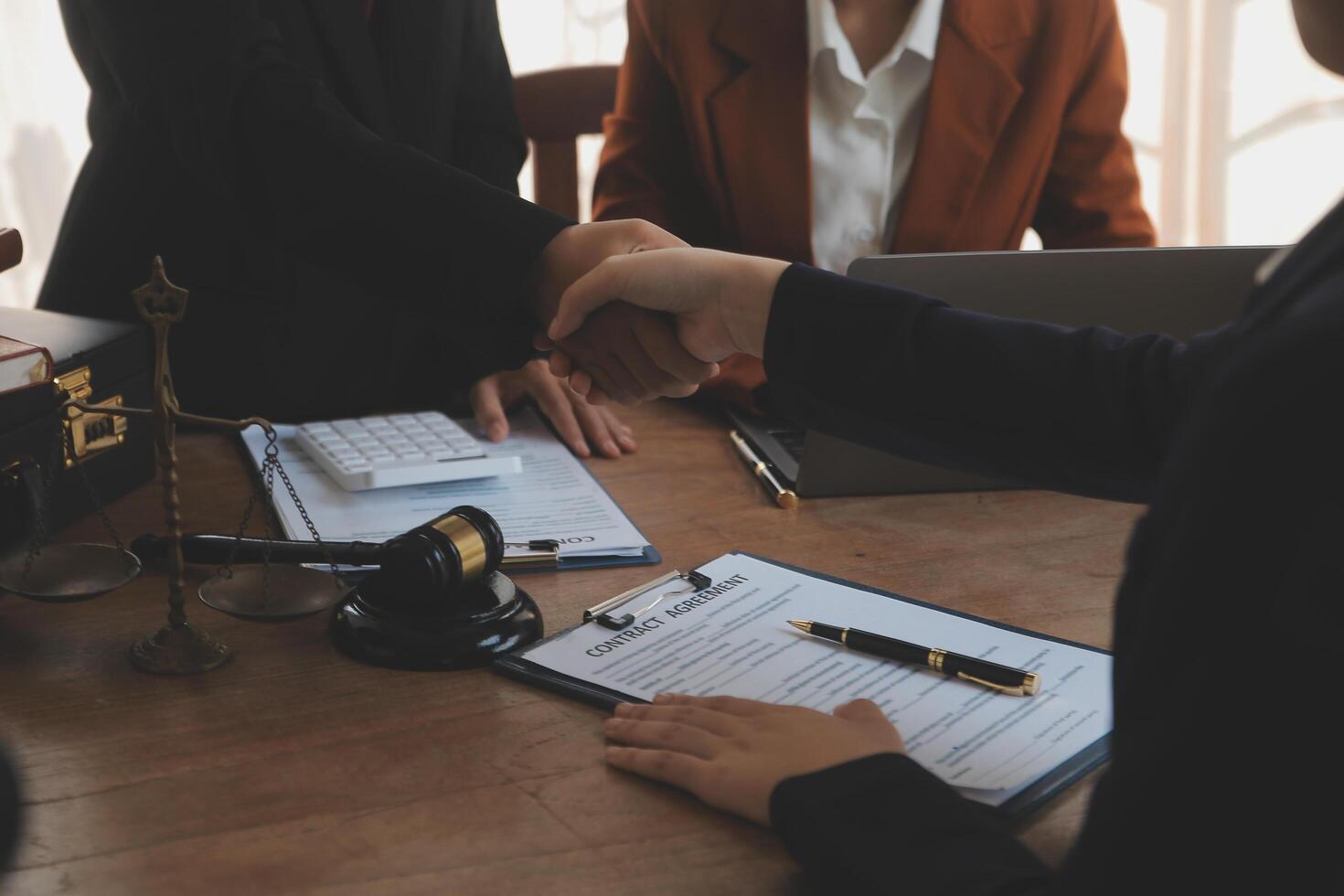 concept of justice and law A male judge in the courtroom on a wooden table and a male counselor or lawyer working in the office. Law, advice and justice concepts. photo