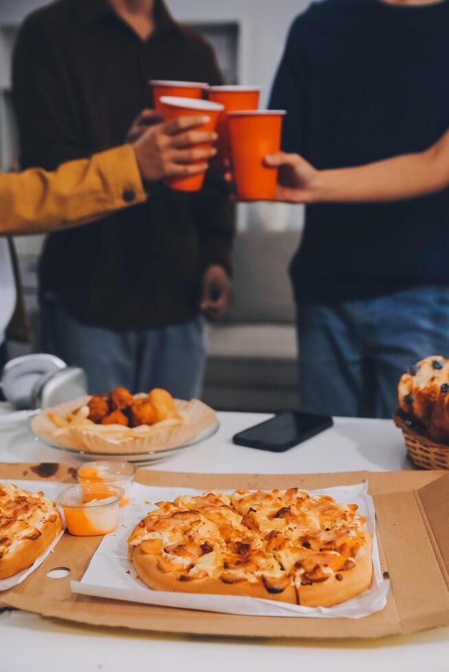 Group of young friends eating pizza.Home party. photo