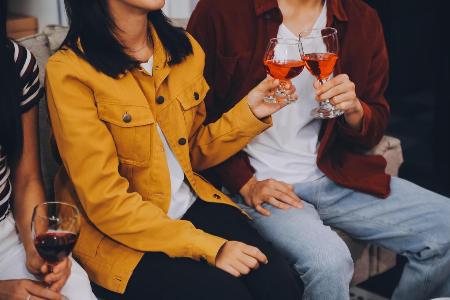 Happy friends making a toast with beer before eating pizza in a shared apartment. photo