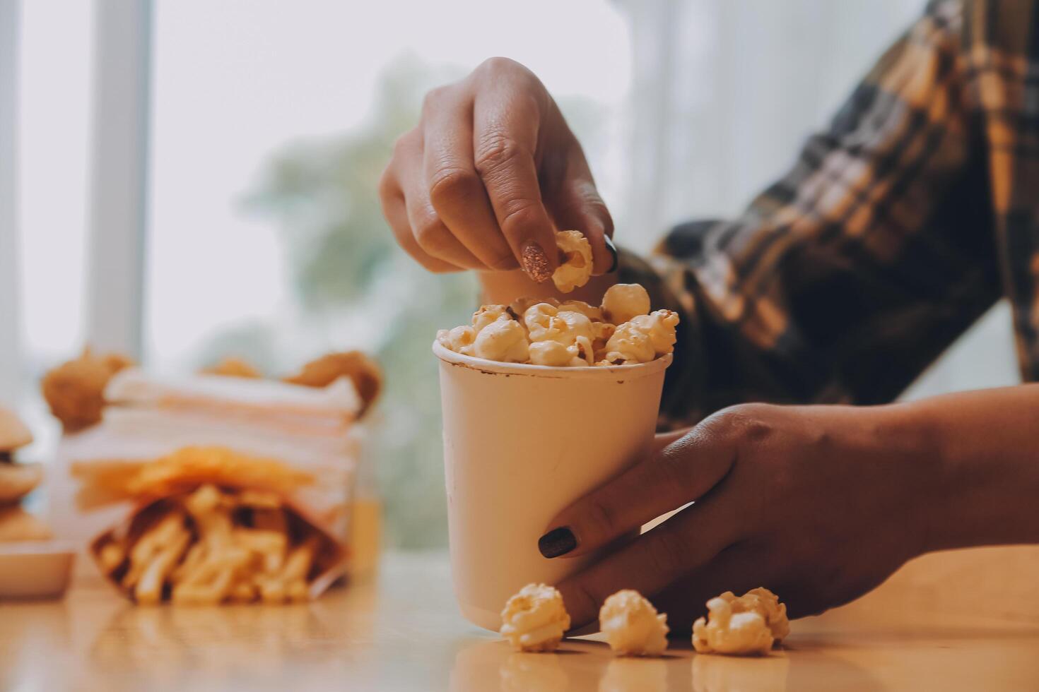 A woman holding a bowl of popcorn photo