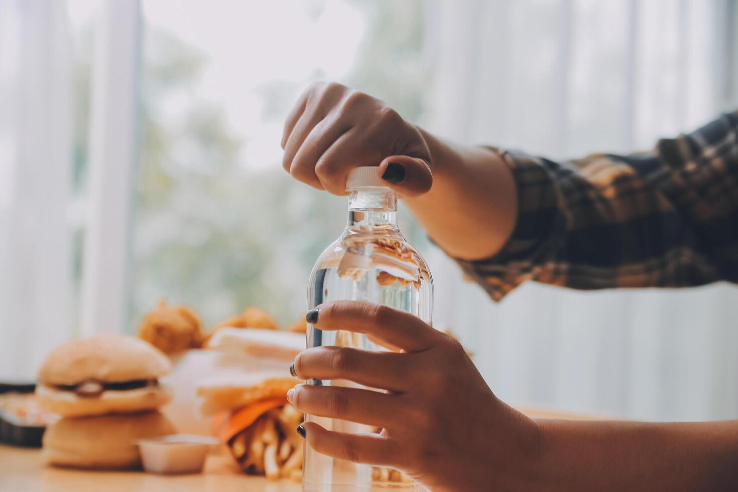 healthy beautiful young woman holding glass of water photo