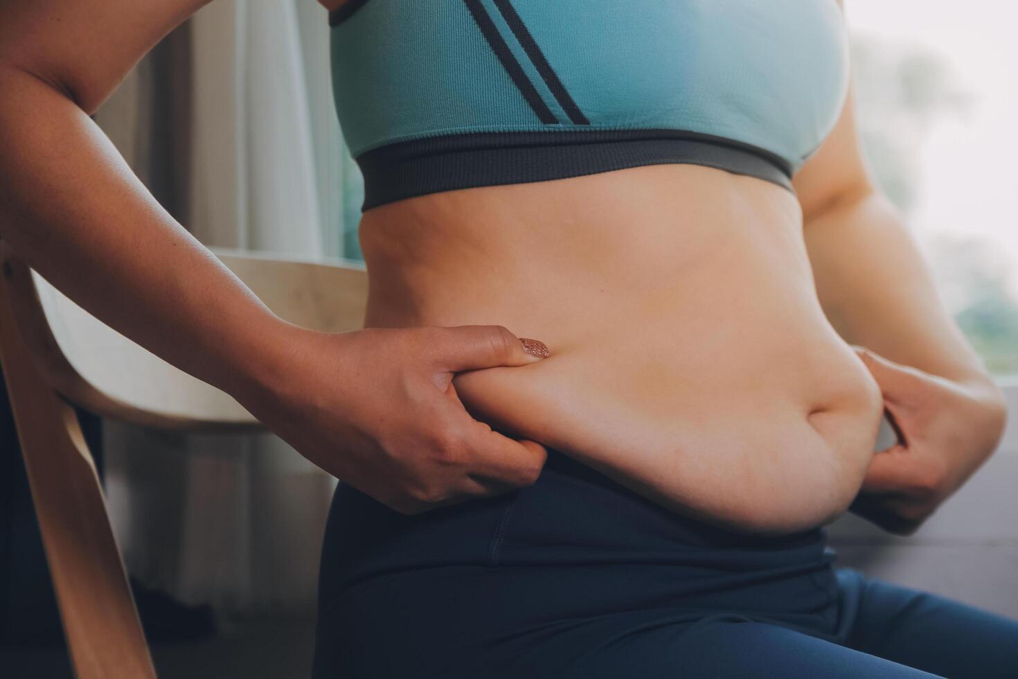 fat woman, fat belly, chubby, obese woman hand holding excessive belly fat with measure tape, woman diet lifestyle concept photo
