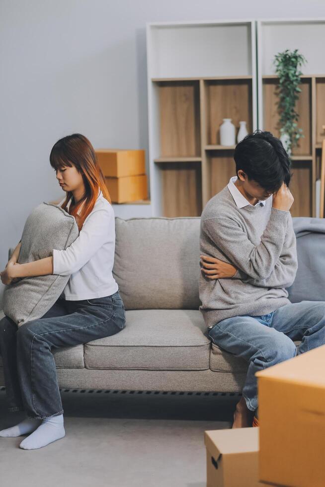 Offended couple ignoring each other after quarrel indoors, selective focus. Relationship problems photo