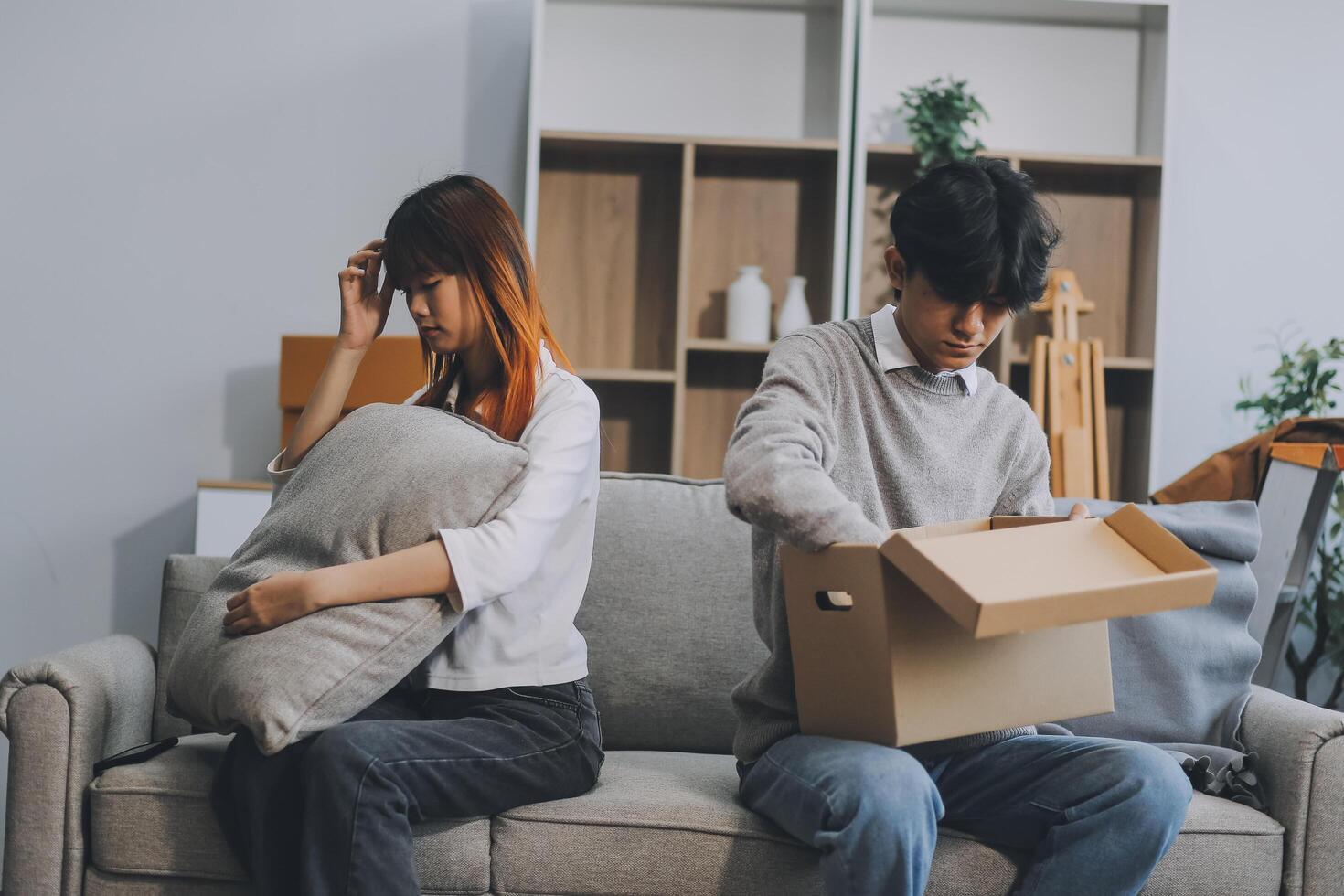 Offended couple ignoring each other after quarrel indoors, selective focus. Relationship problems photo