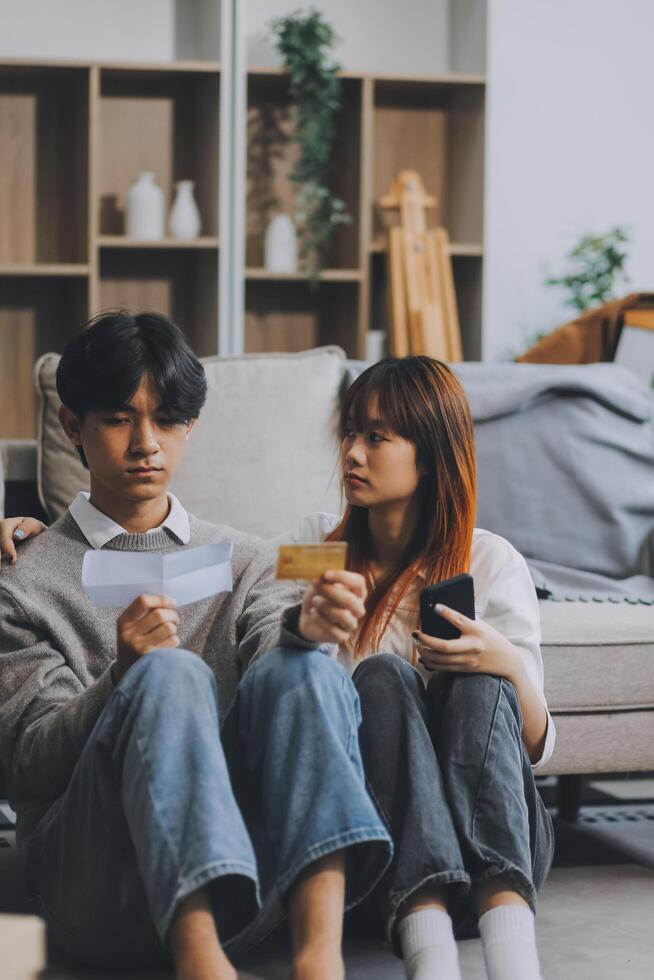 Worried annoyed young husband wife using phone credit card dissatisfied with interrupted wifi internet connection slow bad app work. Angry family couple bank clients unable to pay online check balance photo
