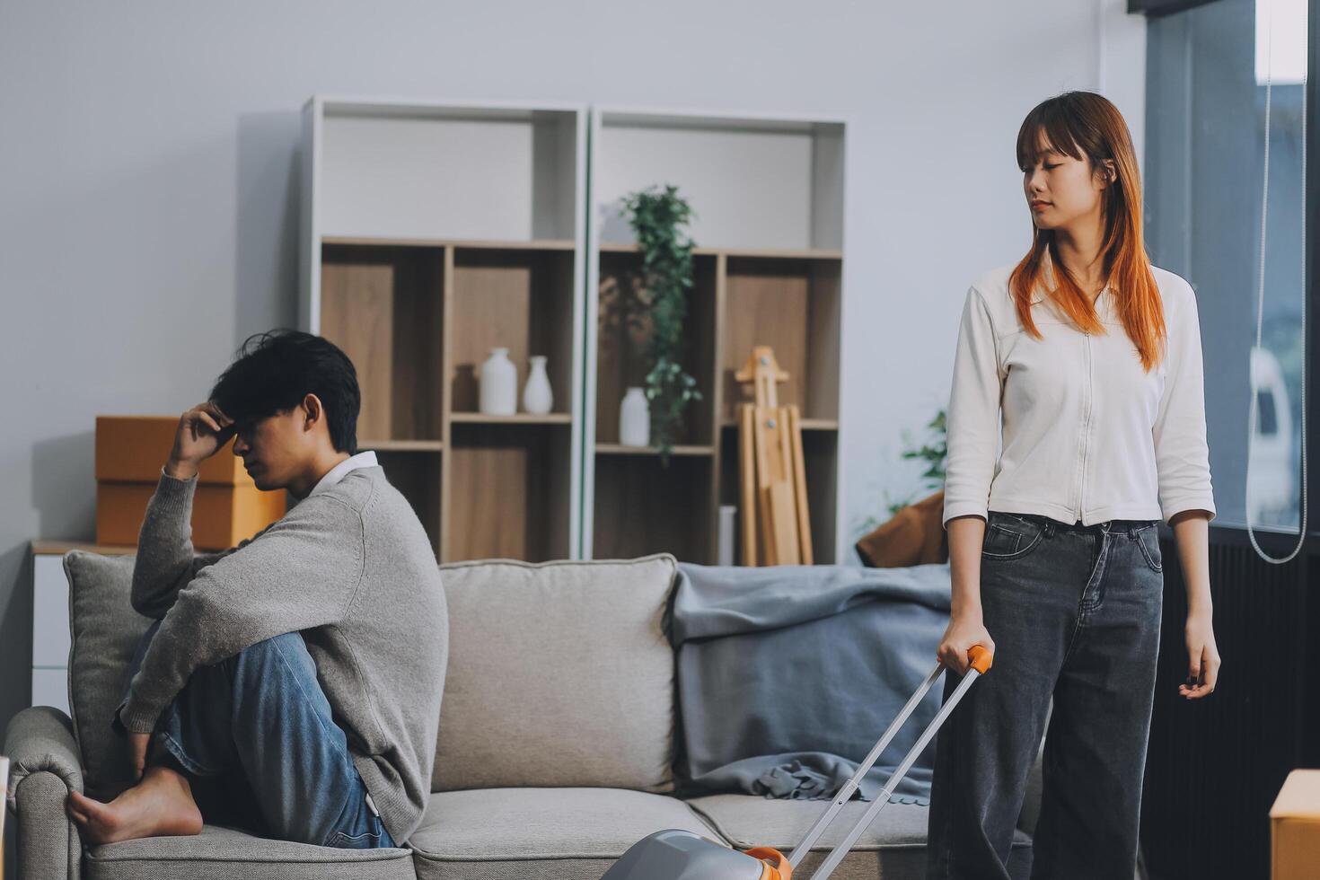Offended couple ignoring each other after quarrel indoors, selective focus. Relationship problems photo