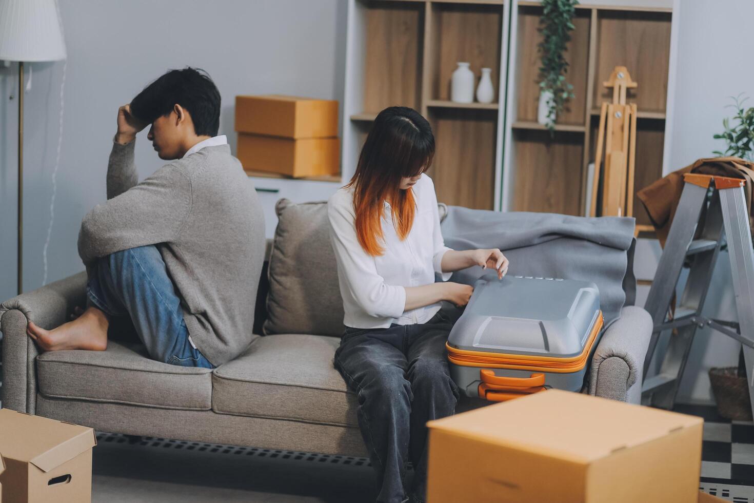 Offended couple ignoring each other after quarrel indoors, selective focus. Relationship problems photo