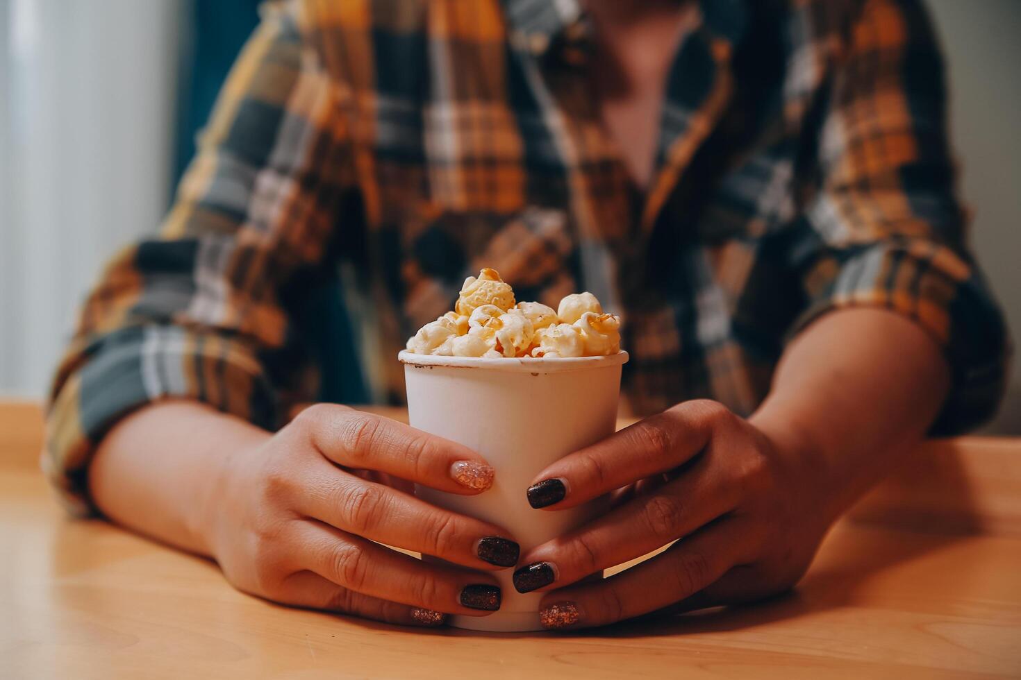 A woman holding a bowl of popcorn photo