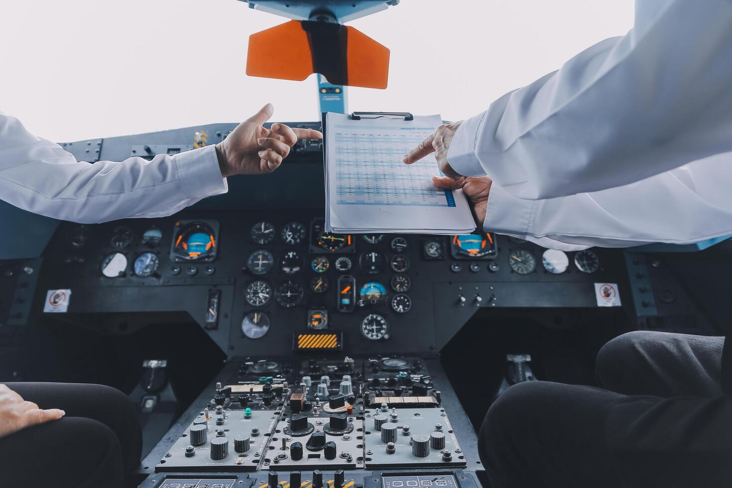 Professional pilot woman in uniform has teamwork meeting for success flight in aviation business. Young female captain instructor sitting in office and working or training commercial airline crew. photo