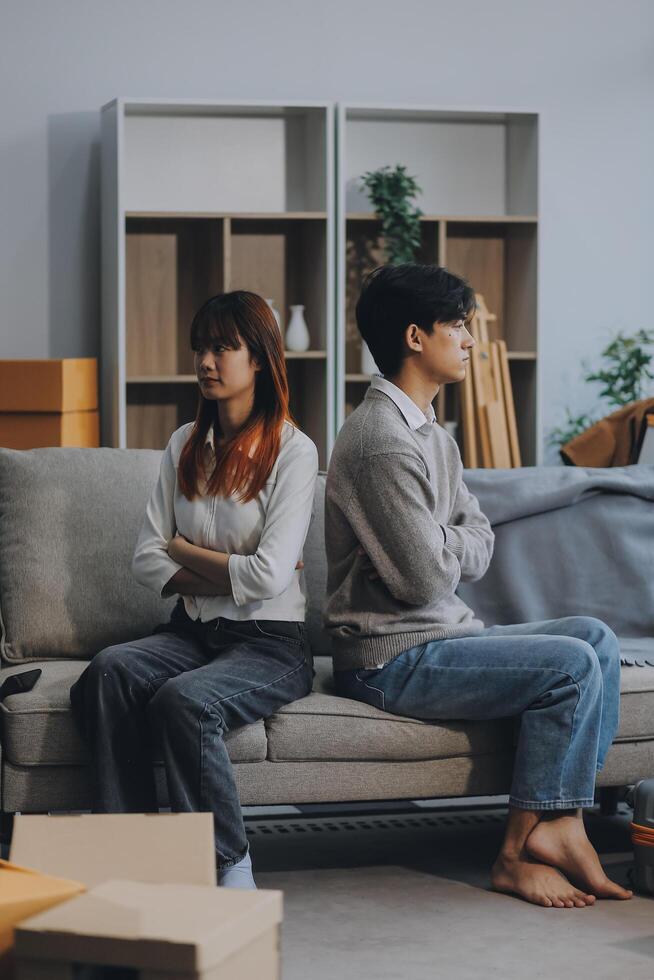 Offended couple ignoring each other after quarrel indoors, selective focus. Relationship problems photo