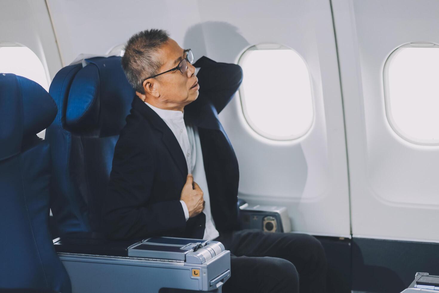 headache in the airplane, man passenger afraid and feeling bad during the flight in plane photo
