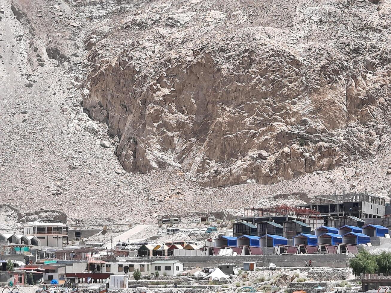 Hunza, Pakistan, 05 July 2024 - Beautiful view of hotels and shops built for tourists on the banks of Attabad Lake in Hunza, Gilgit Baltistan. photo