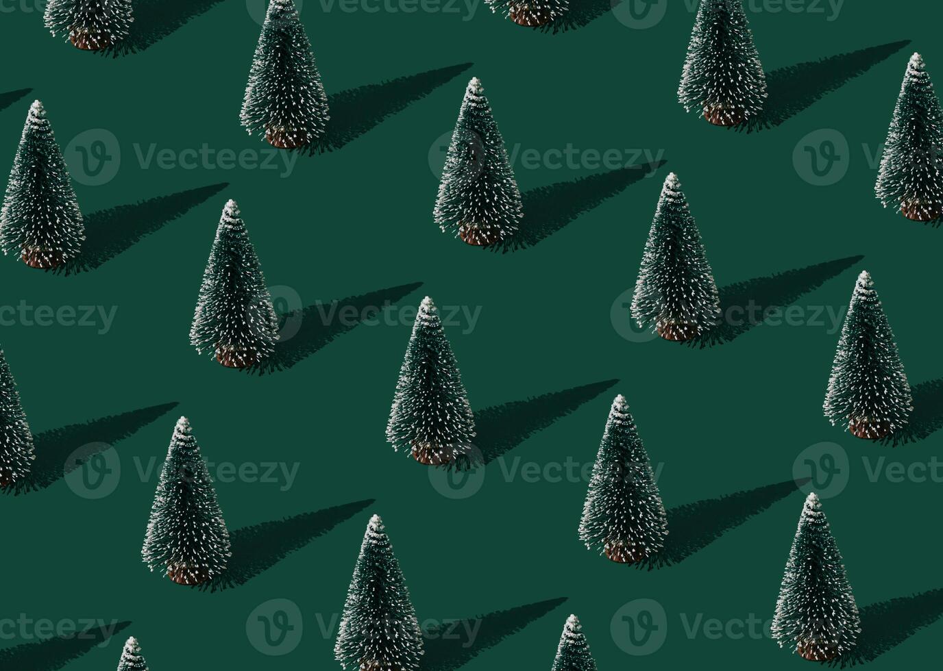 Christmas pattern composition made of green Xmas tree on green background. Creative minimal Christmas and New Year concept. Festive winter holiday pattern backdrop. Christmas aesthetic background. photo