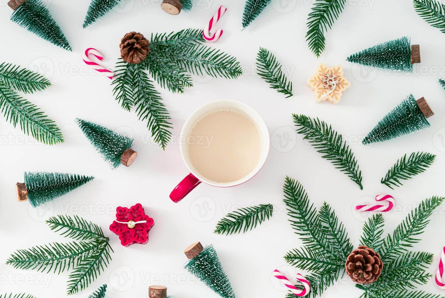 Christmas pattern made of green Xmas trees, snowy branches, candles, Christmas candies and pinecones with cup of coffee on white background. Creative Christmas and New Year concept. Winter flat lay. photo