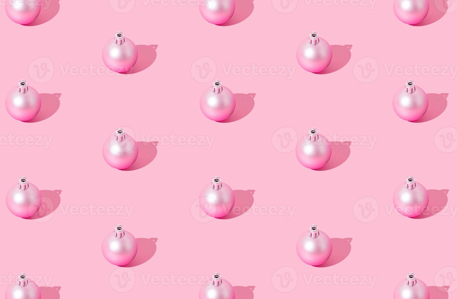 Christmas pattern composition made of pink Xmas bauble on pastel pink background. Creative minimal Christmas and New Year concept. Festive holiday pastel backdrop. Christmas aesthetic background. photo